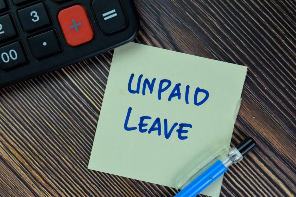 Unpaid leave written on post it note