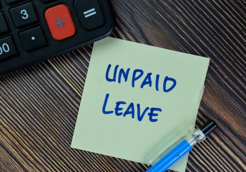 Unpaid leave written on post it note